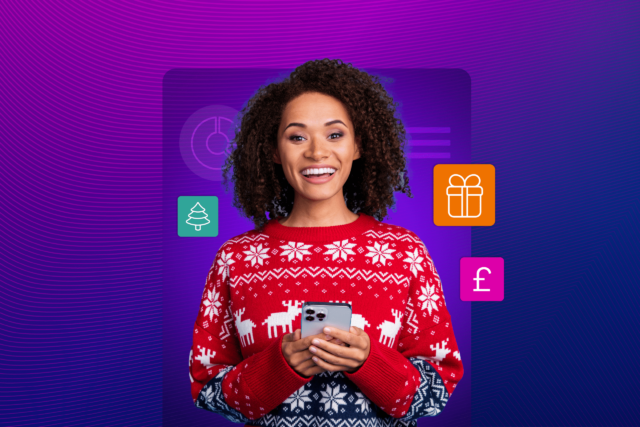 A woman in a Christmas sweater holding a mobile phone in her hands